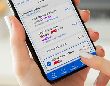 Person on a mobile device finalising an online order, seleting Pick up from Target Kmart in delivery options